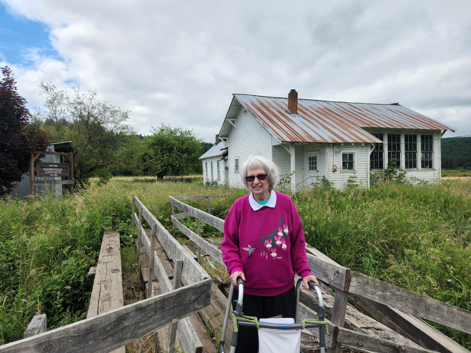 Carol Ponder is pictured near the former one-room Salzer Valley schoolhouse.
